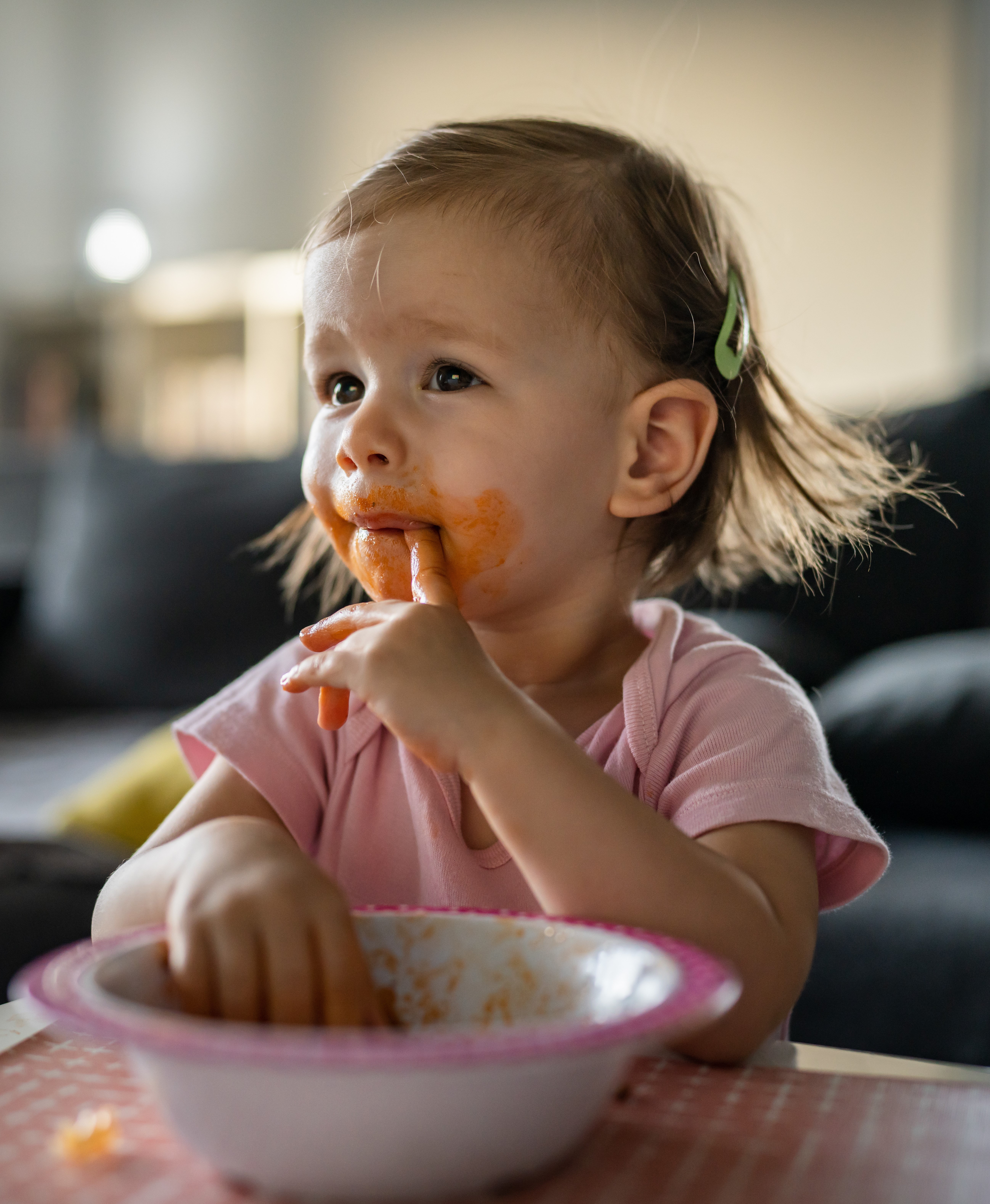 one year old eating from bowl