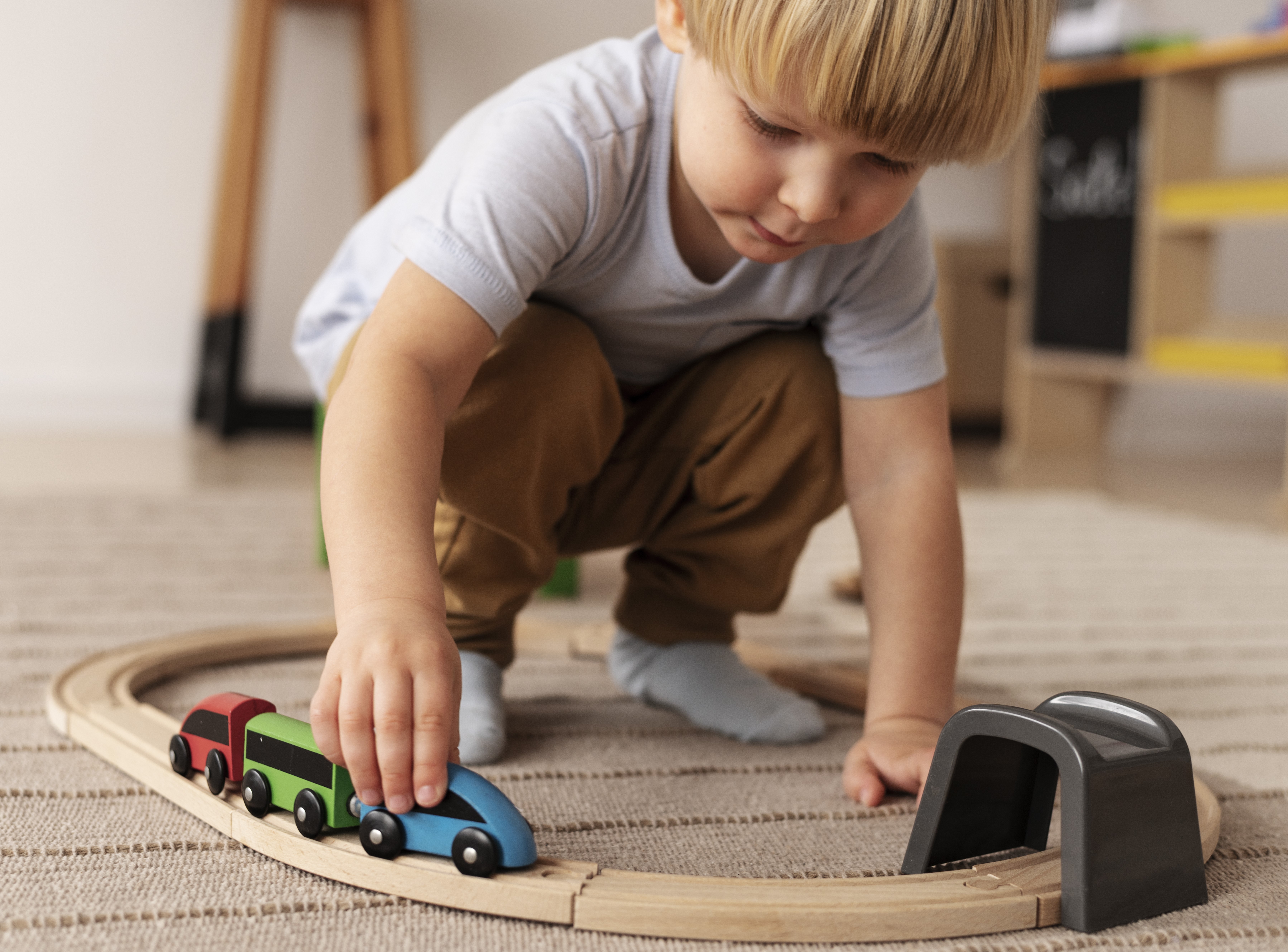 boy playing with toy train