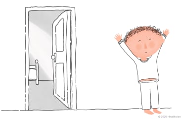 Brannon stands outside his room, ready for the day