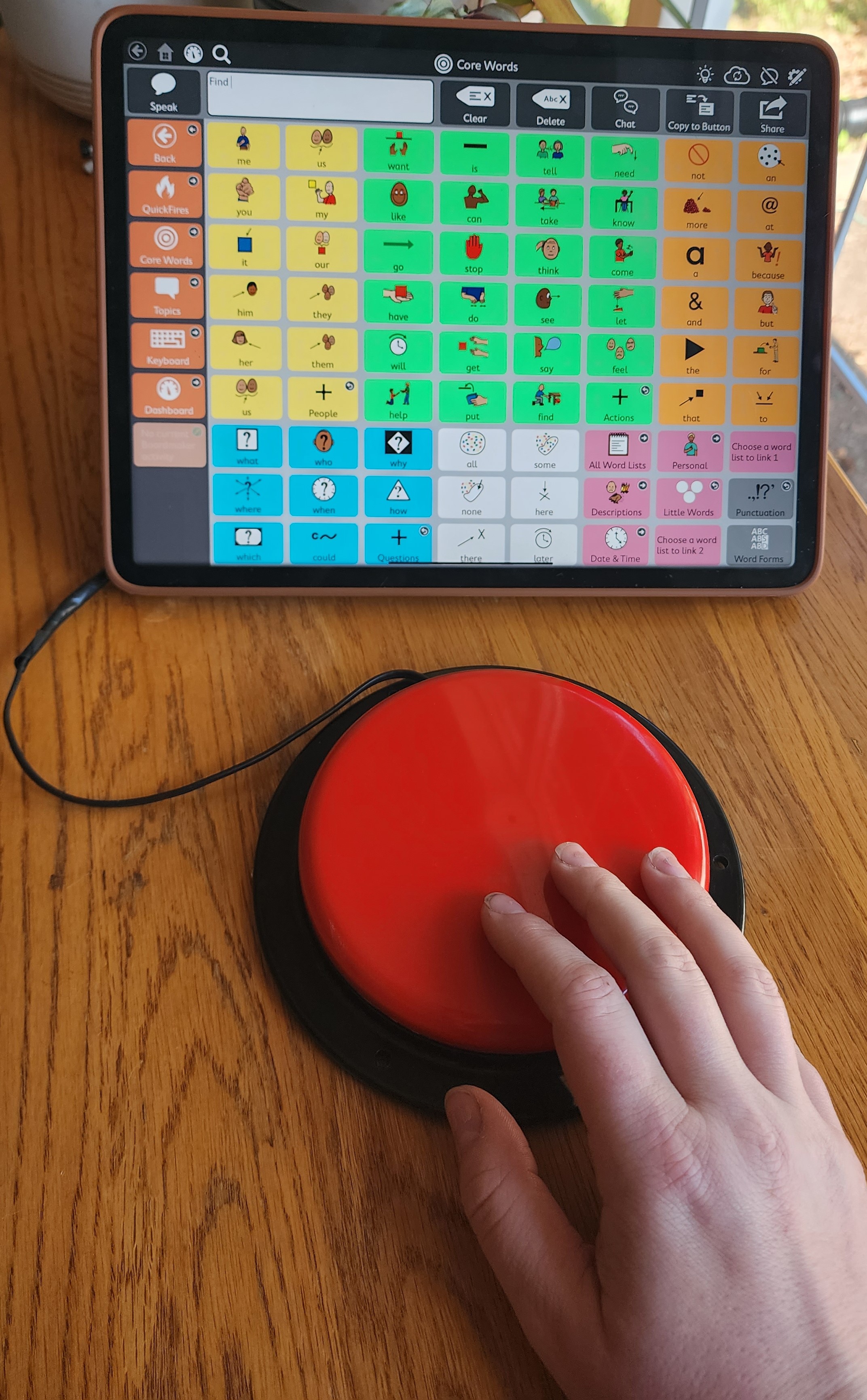 child accessing AAC device with switch