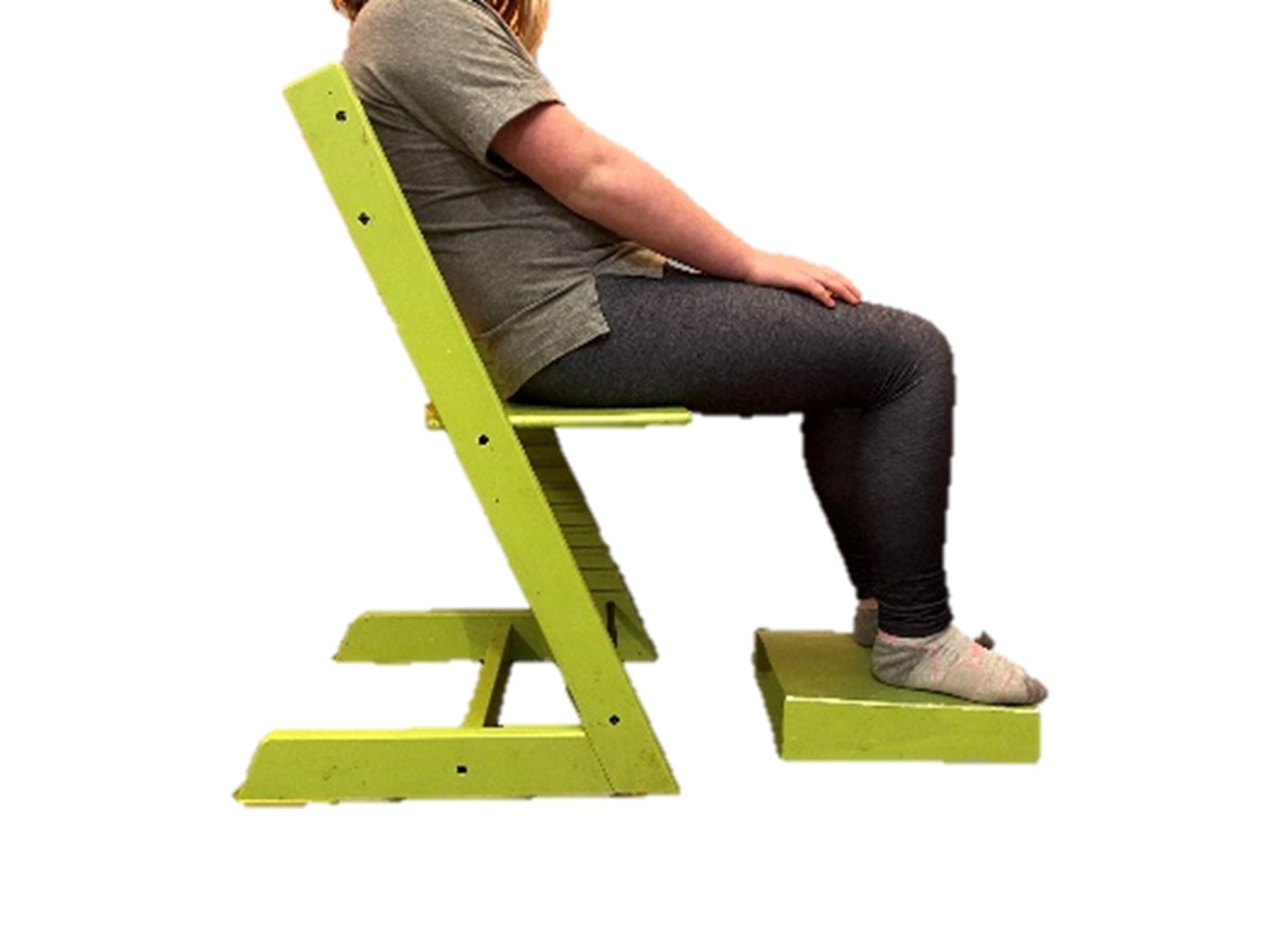 child sitting with bum forward