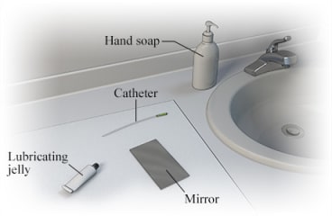 Bathroom sink area, showing supplies of hand soap, catheter, lubricating jelly, and mirror on clean cloth.